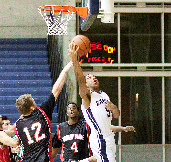 Eagles #5 goes for an acrobatic layup during a 78-50 onslaught against University College. Edward Cai/The Medium
