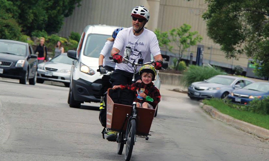 A huge crowd welcomed Andrew Sedmihradsky and his son Max as they cycled to UTM. 